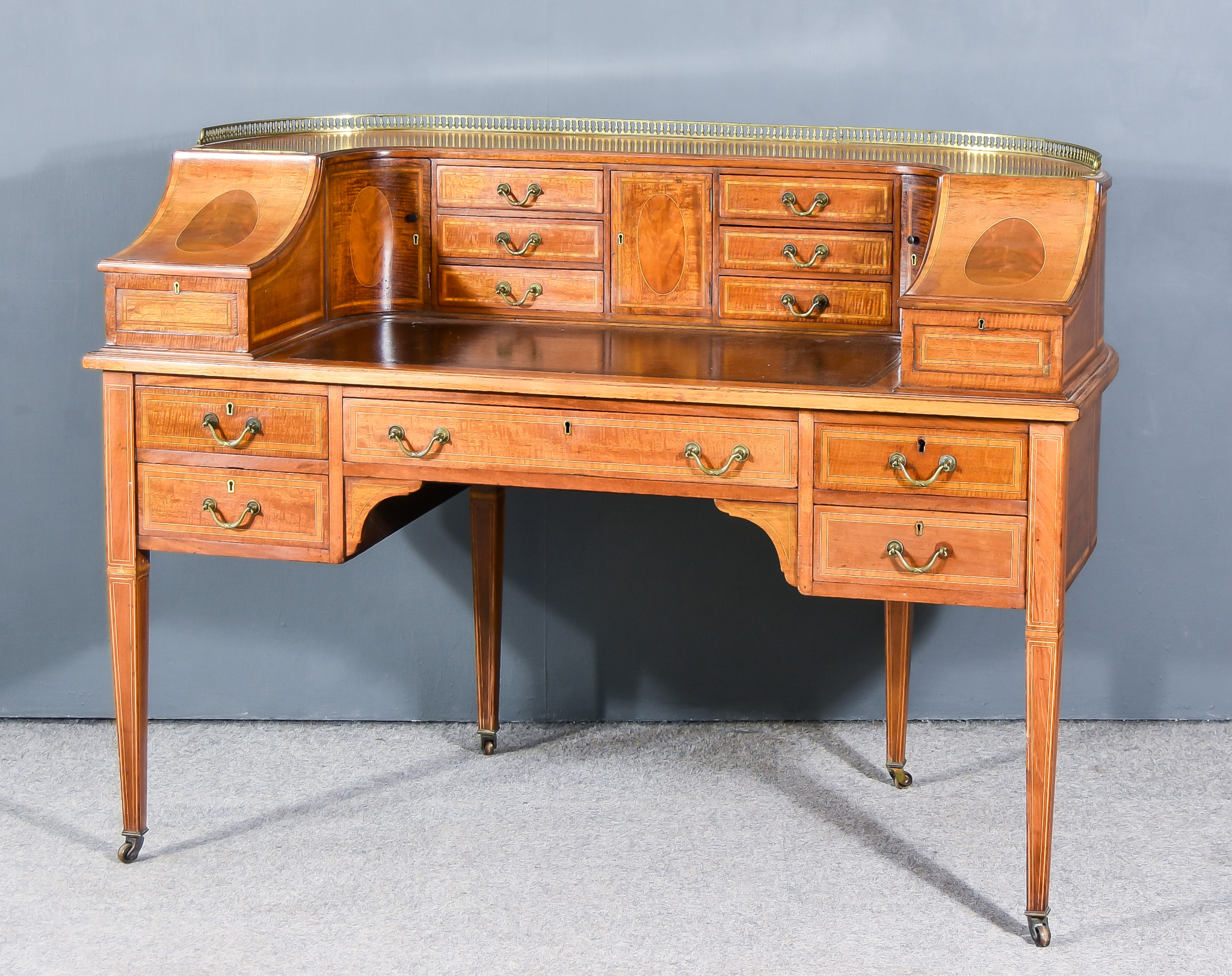 An Edwardian Mahogany "Carlton House" Desk of Sheraton Design, the whole inlaid with satinwood