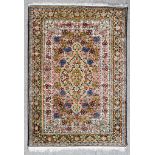 A 20th Century Pure Silk Qum Rug, woven in pastel shades, with a bold stylised central floral