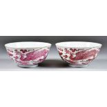 A Pair of Chinese Red and White Porcelain Dragon Bowls, Late 19th / Early 20th Century, painted in