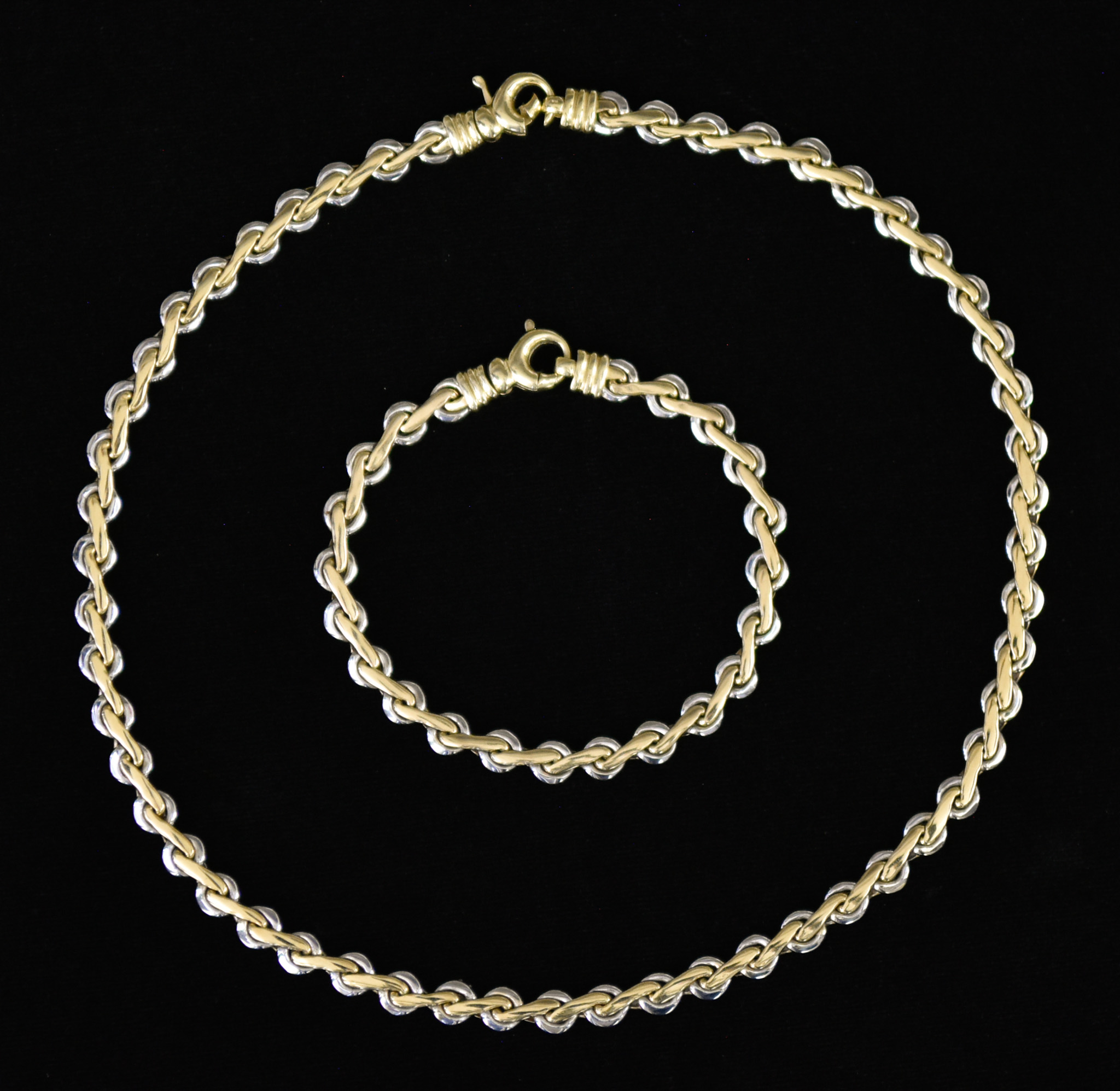 An 18ct Bi-Metal Necklace and Bracelet, Modern, comprising - white and yellow gold twisted link flat