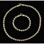 An 18ct Bi-Metal Necklace and Bracelet, Modern, comprising - white and yellow gold twisted link flat