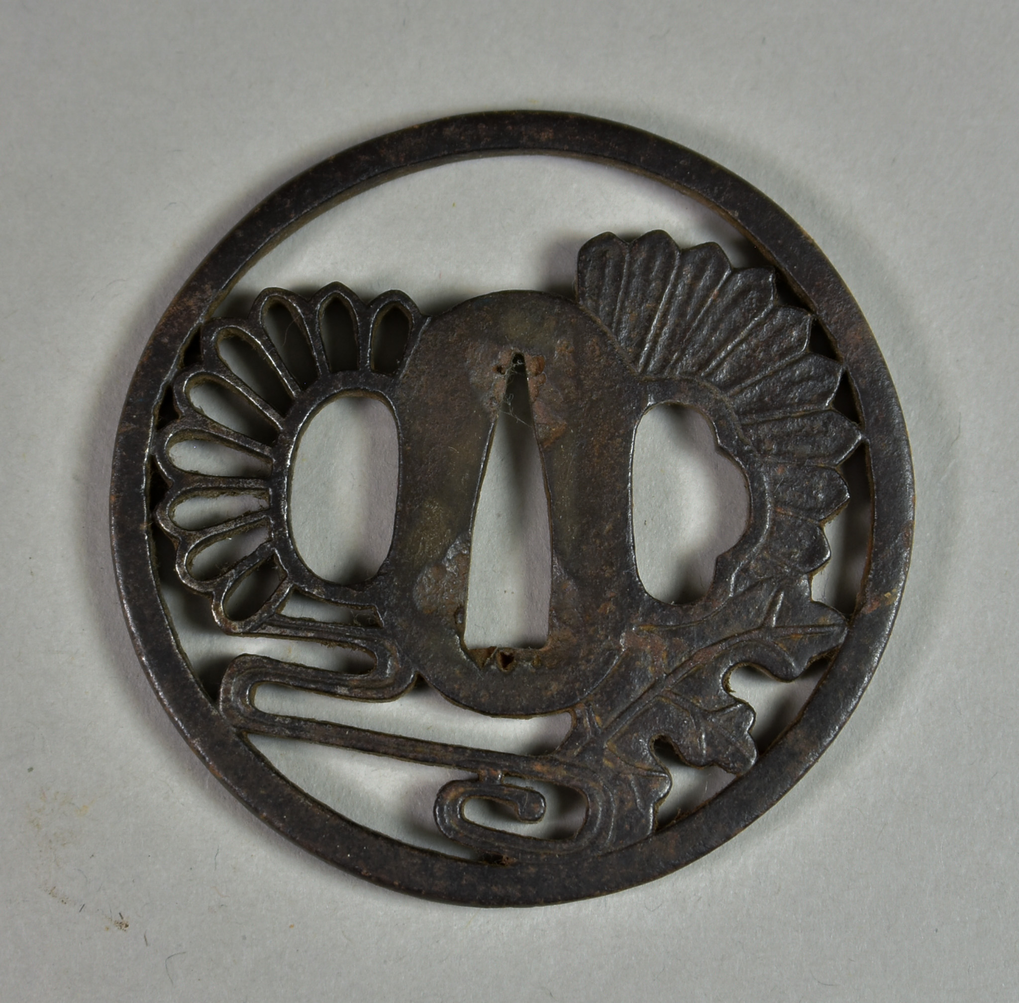 A Japanese Tsuba, iron Maru-gata depicting chrysanthemum and stream, Edo period (1615-1868), 3ins