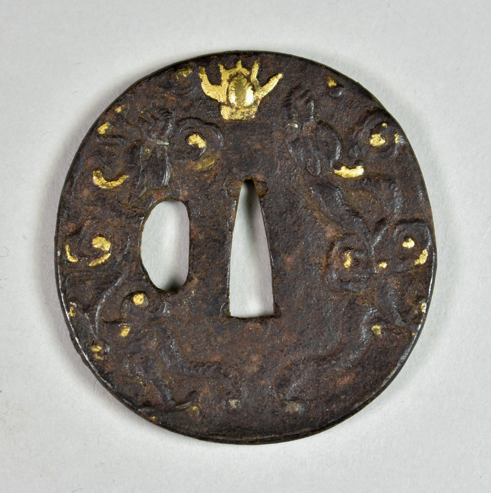 A Japanese Tsuba, iron Mokko-gata depicting dragons chasing the sacred pearl, Edo period (1615-