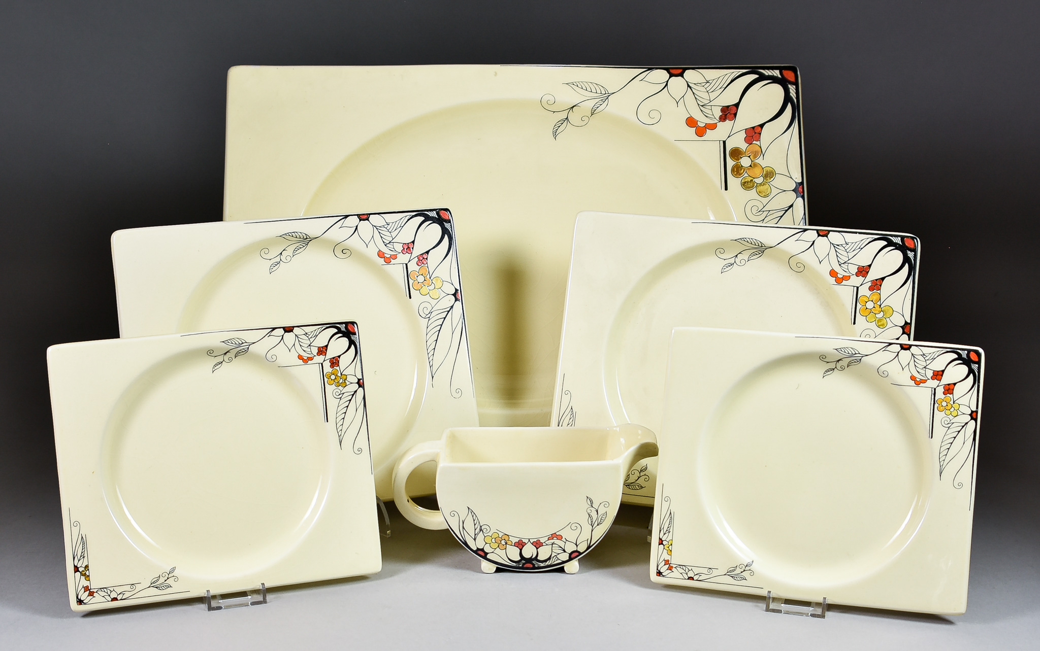 A Clarice Cliff Biarritz Part Dinner Service, in "Grill" Pattern, enamelled in red, orange, yellow