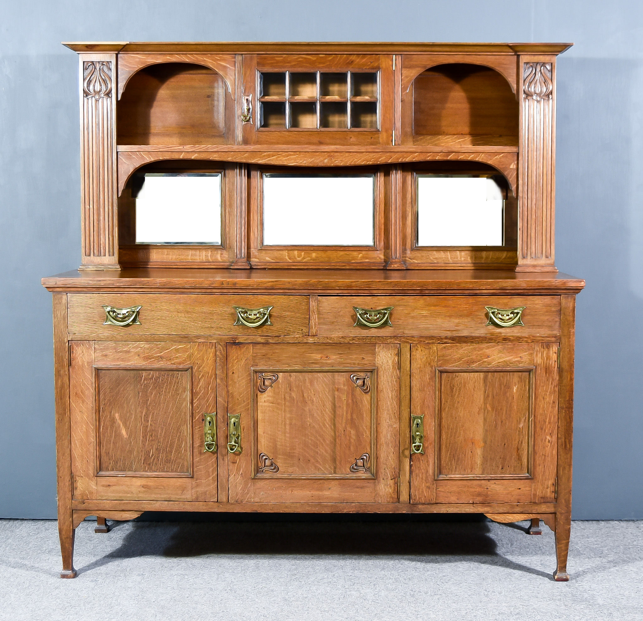 A Victorian Oak Dresser of Art Nouveau Design, the upper part with moulded cornice fitted with one