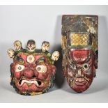 A Nepalese Grotesque Wall Mask and a Chinese Painted Wood Opera Mask, the Nepalese mask painted in