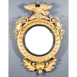 An Early 19th Century Gilt Framed Circular Convex Wall Mirror, with moulded frame and ball ornament,