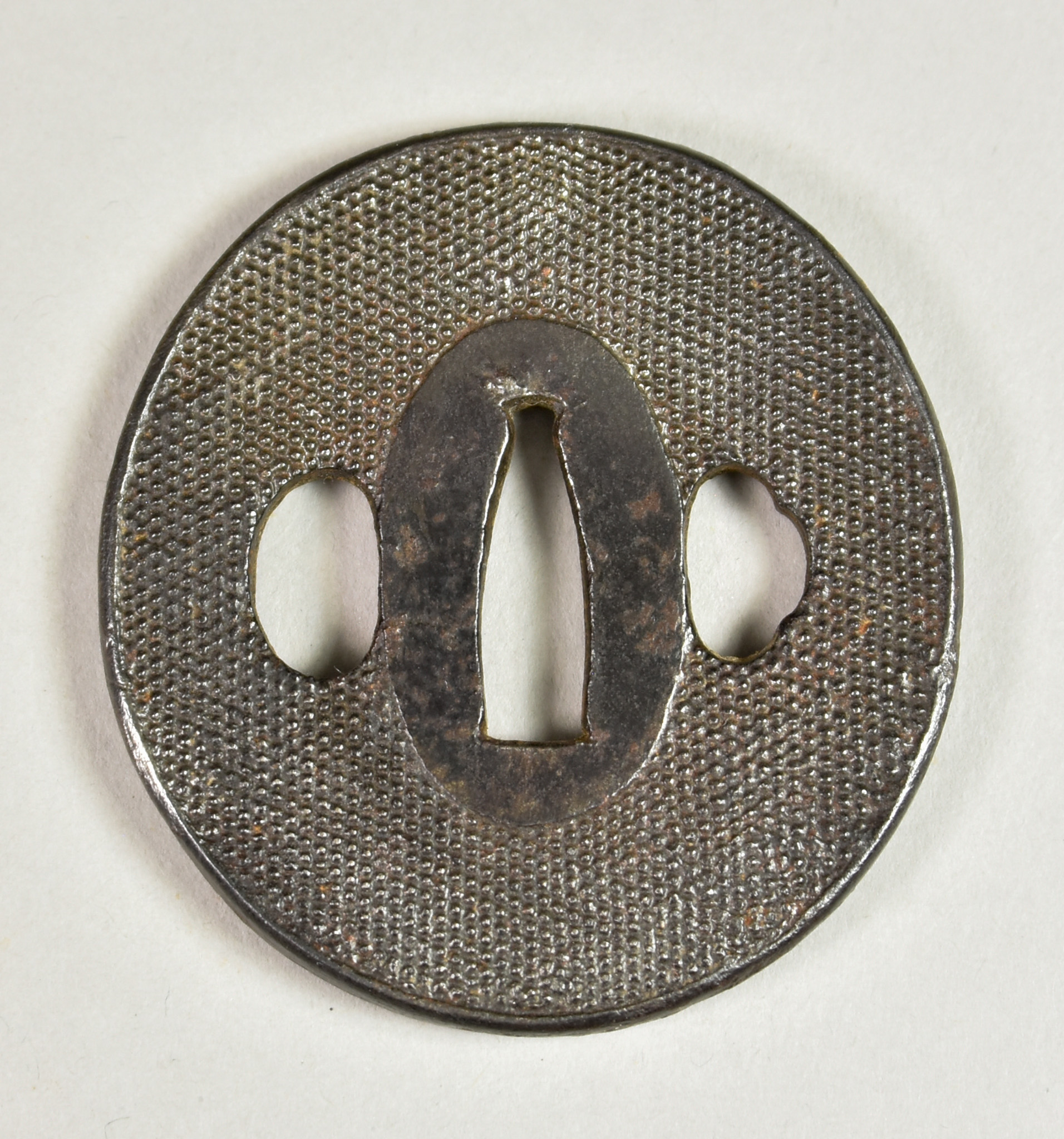 A Japanese Tsuba, iron Naga Maru-gata depicting a nanko ground, Edo period (1615-1868), 3ins - Image 2 of 2