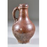 A 17th Century German Salt Glaze Stoneware Bartmann Krug of Small Proportions, 7ins high