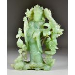 A Green Hardstone Carving of Guan Yin, 20th Century, depicting Guan Yin with a small child
