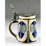 A German Salt Glazed Stoneware Stein with Flat Pewter Lid and Scroll Thumb Piece, Early 20th