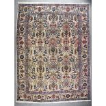 An Antique Tabriz Carpet, woven in pastel shades, the field filled with stylized urns and flowers on
