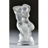 A Lalique Frosted Glass Model of an Embracing Nymph and Faun on oval base 5.5ins high, with etched