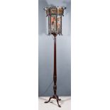 A Japanese Wood Framed and Painted Glass Hexagonal Lantern on Mahogany Circular Torchere, the