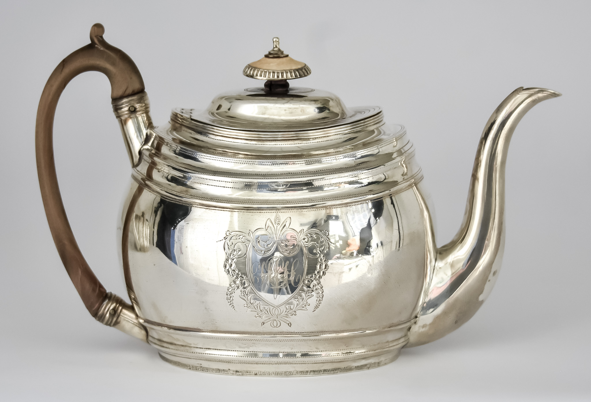 A George III Silver Oval Teapot, by Solomon Hougham, London 1802, with domed cover, stepped rim,