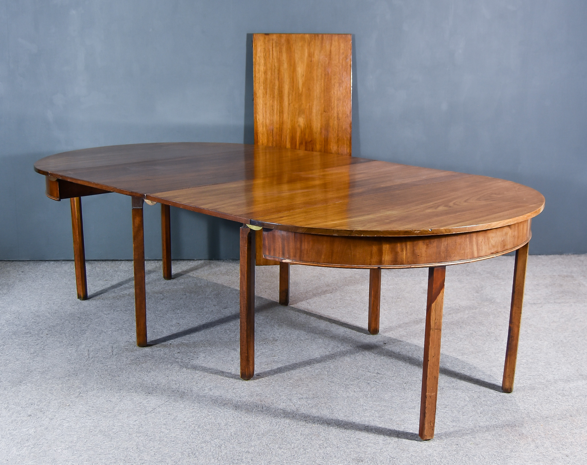 A Georgian Mahogany D-End Extending Dining Table, comprising two D-end sections, with square top