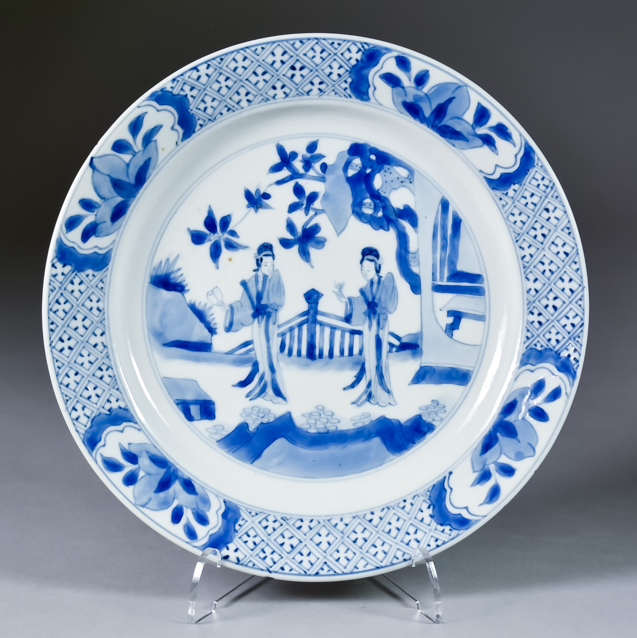 A Chinese Blue and White Porcelain Plate, Kangxi, painted with two ladies in a fenced garden, 8.