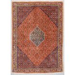 An Antique Bidjar Rug, woven in colours of ivory,navy blue and wine, with a central hexagonal gul,