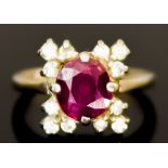 A 14ct White Gold Ruby and Diamond Ring, 20th Century, set with a centre faceted ruby, approximately