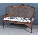 A Late 19th Century Walnut Framed Settee of Louis XV Design, the shaped and moulded back with floral