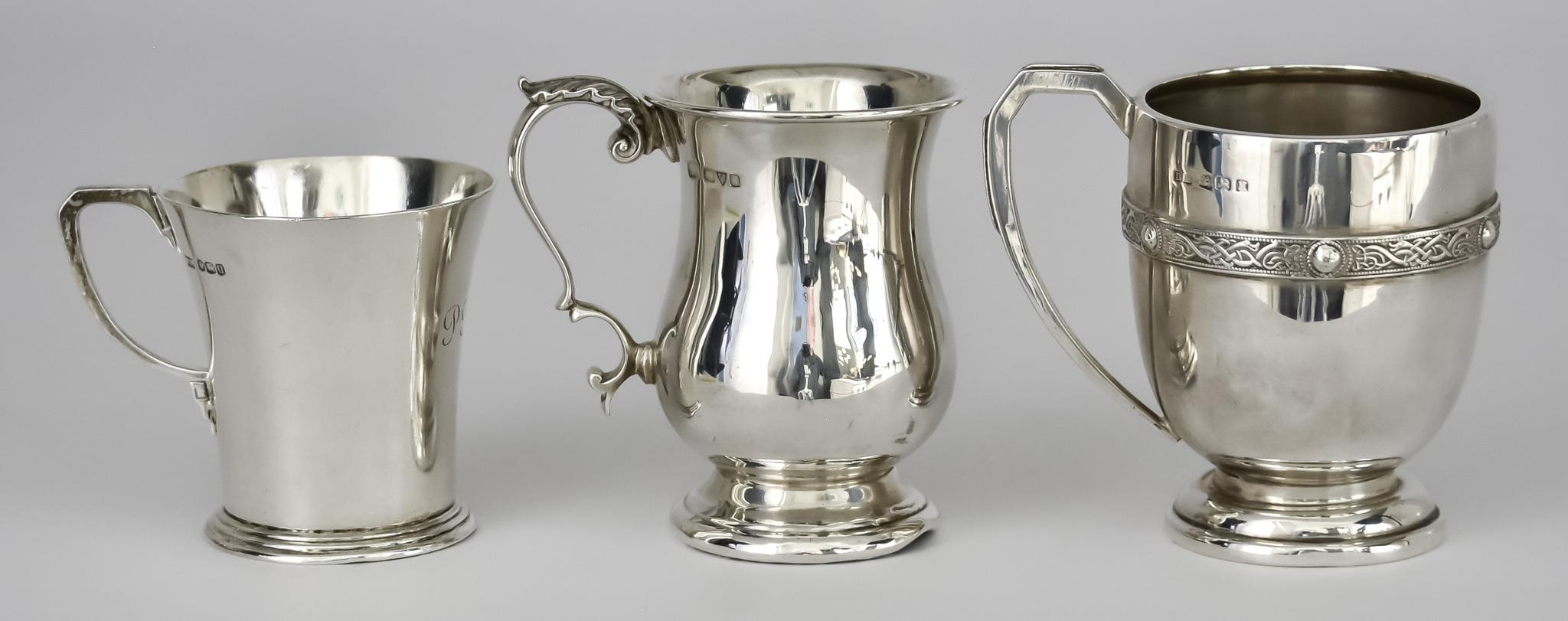 A George V Silver Baluster-Shaped Christening Mug and Two Others, the George V mug by Barker Bros,