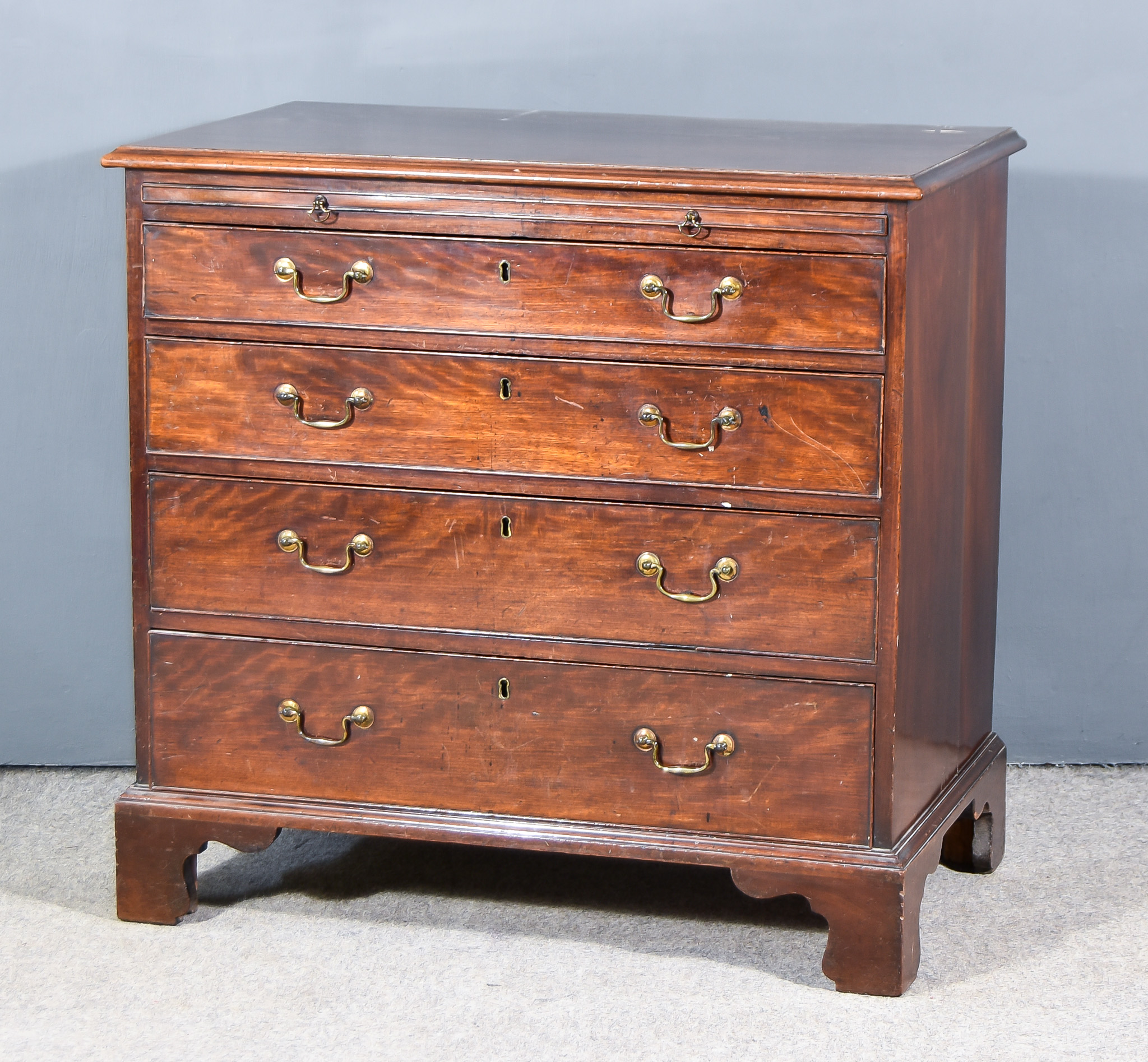 A Late George III Mahogany Chest, with moulded edge to top, fitted brushing slide and four long