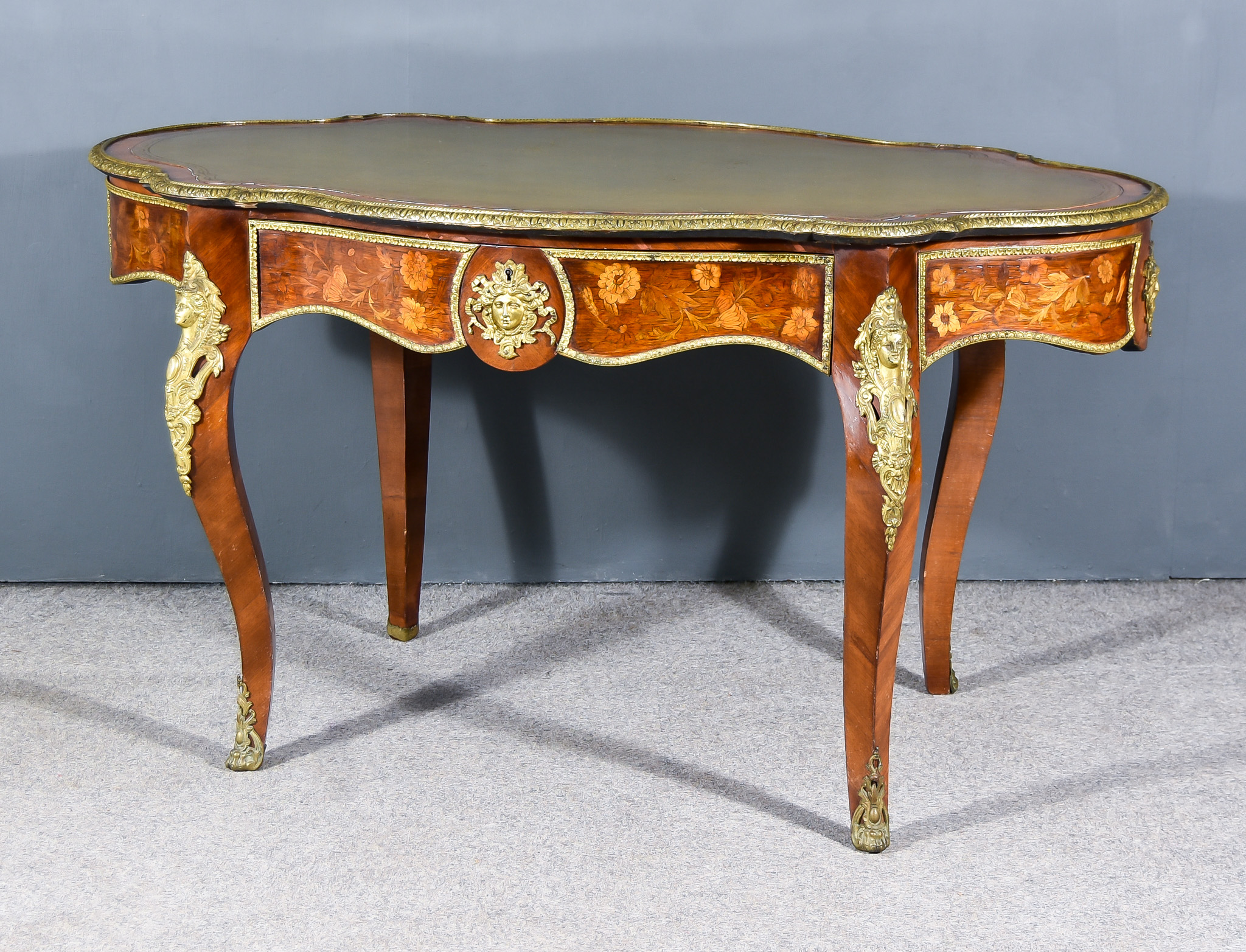 A 19th Century Continental Marquetry and Gilt Metal Mounted Centre Table, of lobed outline, the