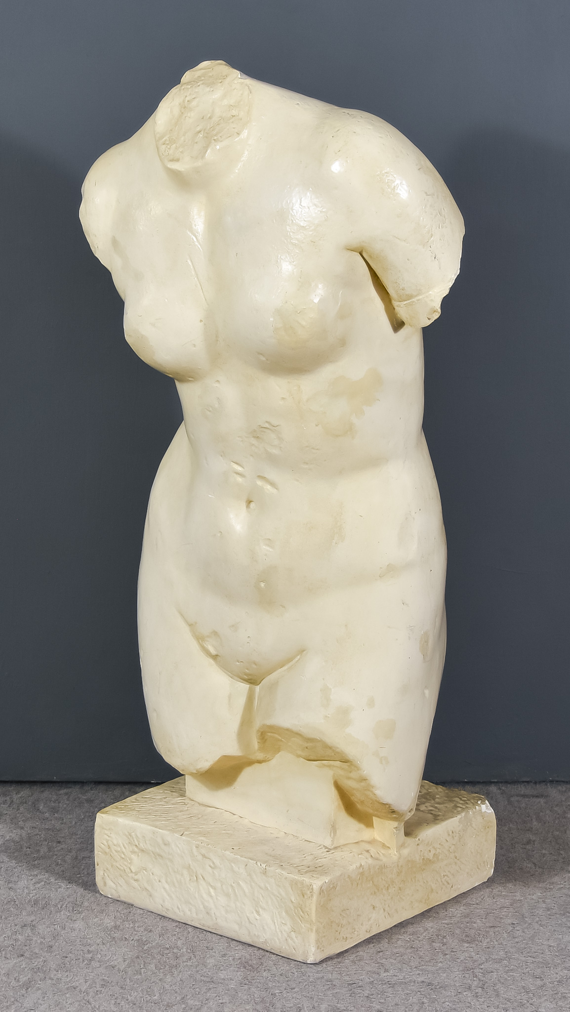 A Plaster Cast After the Antique, of the torso of a Greek female goddess, on square base, 43ins