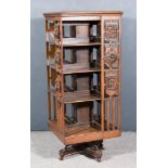 An Early 20th Century Oak Four Tier Revolving Bookcase, three tiers with panels carved with flowers,