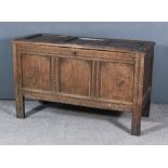 A 17th Century Panelled Oak Coffer, with three fielded panels to lid, and front carved frieze and