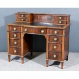 An Edwardian Mahogany Bow and Breakfront Kneehole Desk, inlaid with stringings, inset with leather