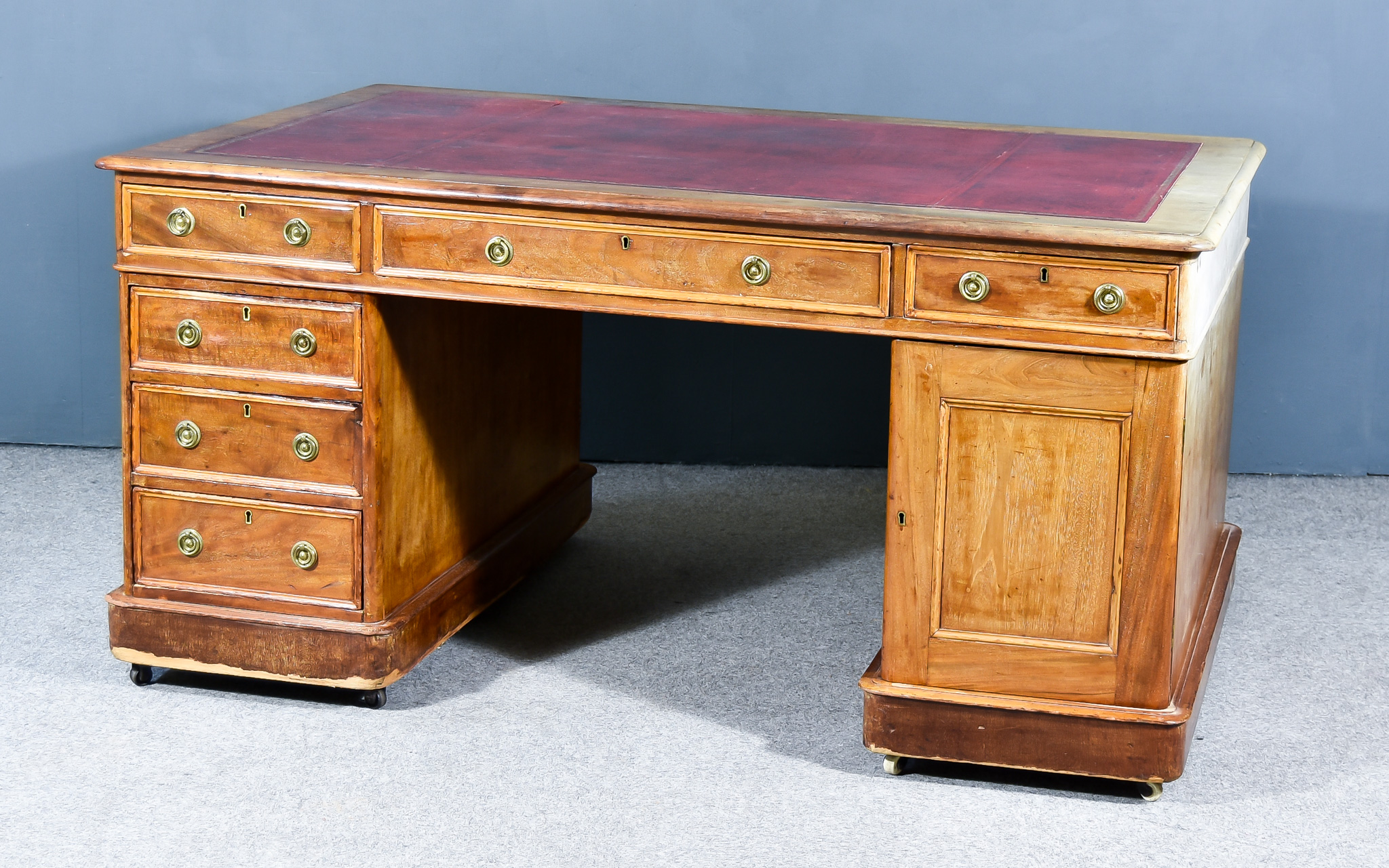 A Victorian Mahogany Partners Desk, with moulded edge to top, inset with red and gilt leather, three