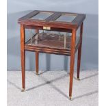 A Early 20th Century Mahogany Rectangular Cocktail Table, the top with twin panels opening to reveal