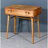 An Ercol Elm and Beech "Windsor" Desk, Model 437, fitted one frieze drawer, on square tapered and