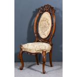 A 19th Century Walnut Framed Nursing Chair, oval back with fretted and carved framework, the seat