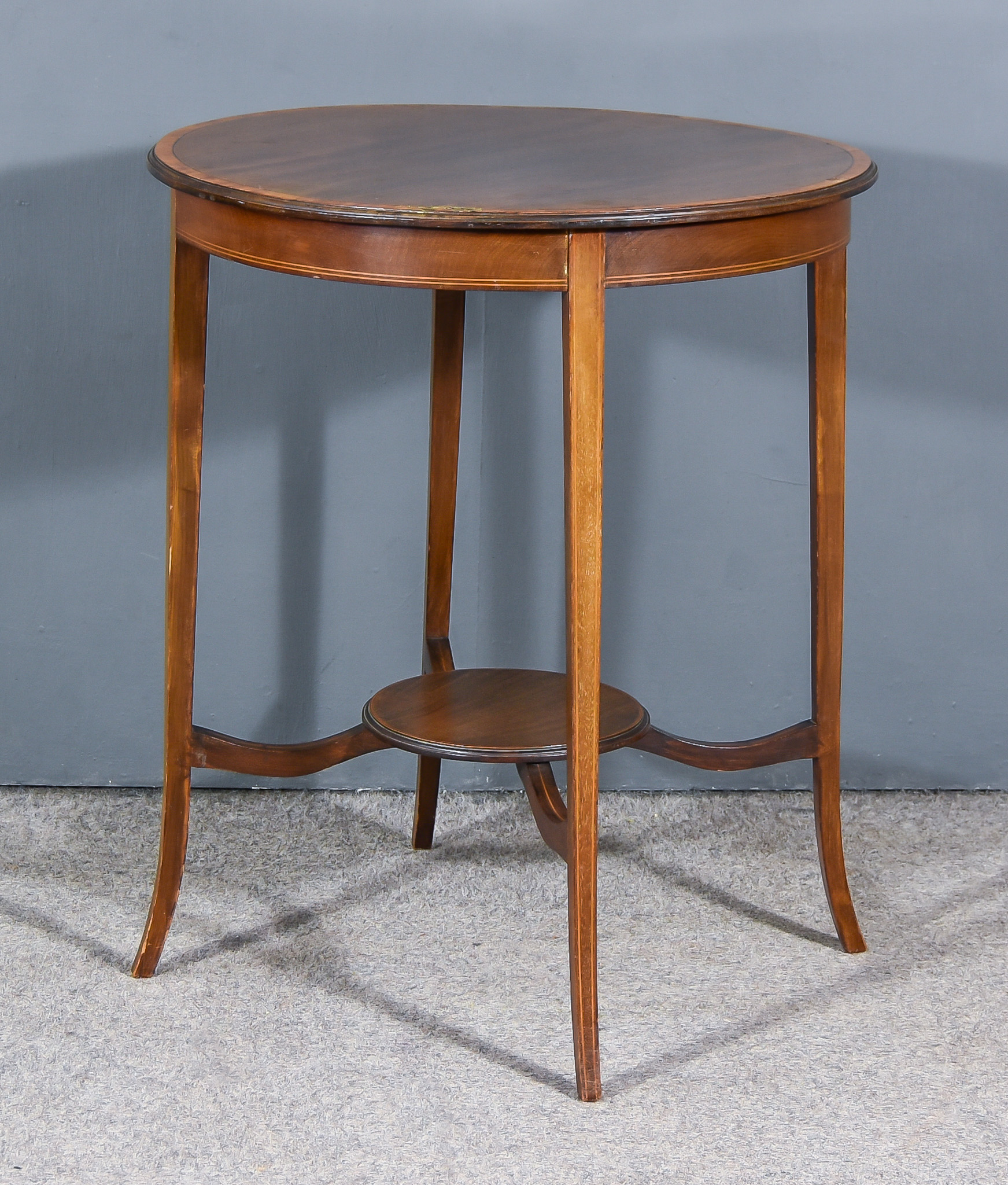 An Edwardian Mahogany Two Tier Occasional Table, with moulded edge and cross-banding to top,