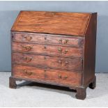 A George III Mahogany Bureau, the slope enclosing pigeon holes, one long drawer flanked by four
