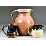 A Winchcombe Pottery Jug, 20th Century, with cream glazed interior and rim 8.25ins high, with