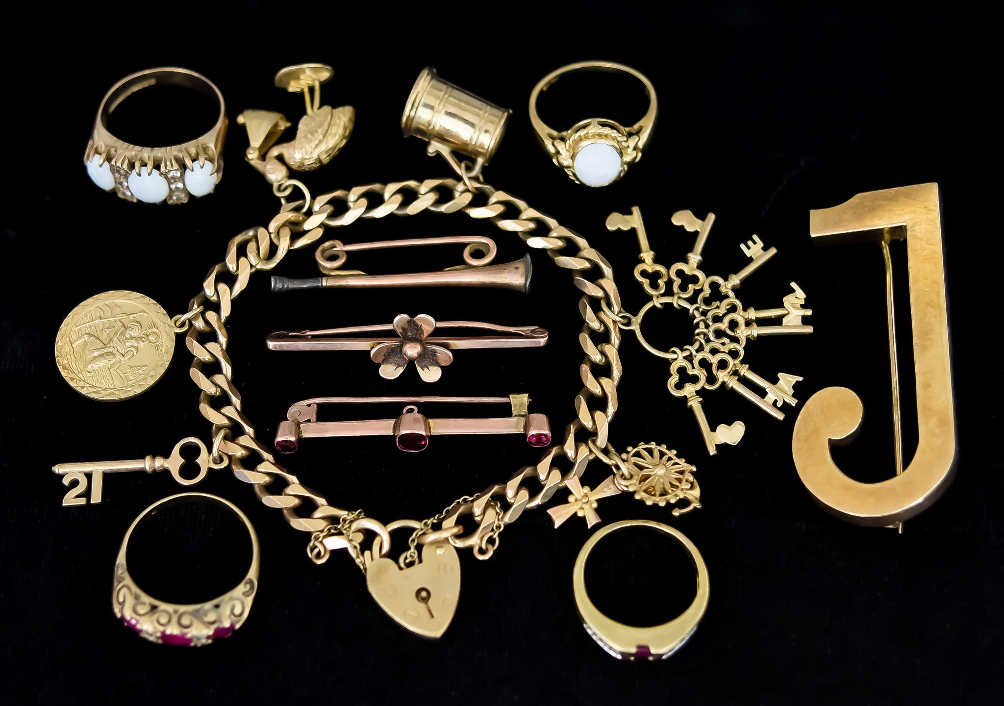 A Mixed Lot of 9ct Gold, comprising - charm bracelet with seven charms, various, brooch depicting