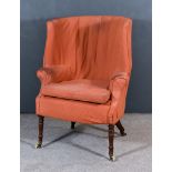 A 19th Century Mahogany Tub Shaped Wing Back Easy Chair, upholstered in orange cloth and on turned