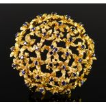 An 18ct Gold Circular Gem Set Brooch, Modern, in the form of flower heads set with small blue stone,