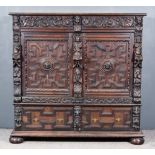 A 19th Century Panelled Oak Cabinet of 17th Century Design, with moulded edge to top, fitted two