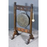 A Brass Gong on Victorian Oak Stand of Arts and Crafts Design, the gong 14ins diameter, on stand