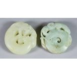 Two Chinese Green Hardstone Circular Plaques, one of pale colour and carved with a toad 2ins (5.2cm)