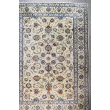 A 20th Century Kashan Carpet, woven in pastel shades, the field filled with palmettes and trailing