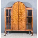 A 1930s Figured Walnut Display Cabinet of Art Deco Design, fitted two central shelves, enclosed by a