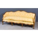 A 19th Century French Walnut Framed Settee, with shaped and moulded frame, with floral and leaf