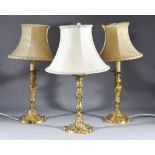 Three French Gilt Brass Candlesticks of Louis XV Design chased and cast with floral leaf scroll