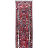 A 20th Century Rudbar Runner, woven in colours of ivory, navy blue and wine, the field filled with