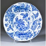 A Chinese Blue and White Shallow Bowl, Kangxi, the centre painted with rock work and flowering